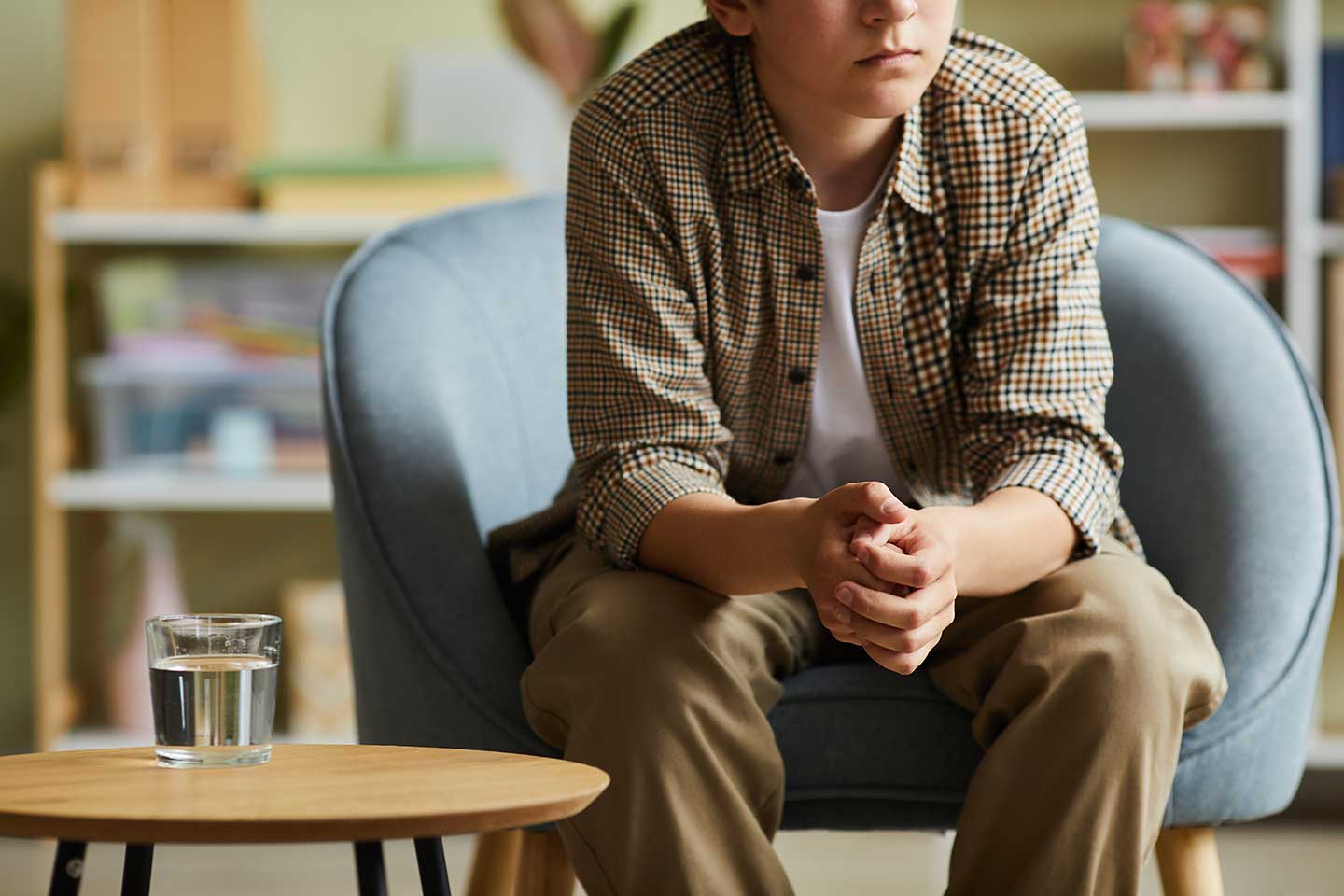 teenage-boy-sitting-at-psychotherapist-office